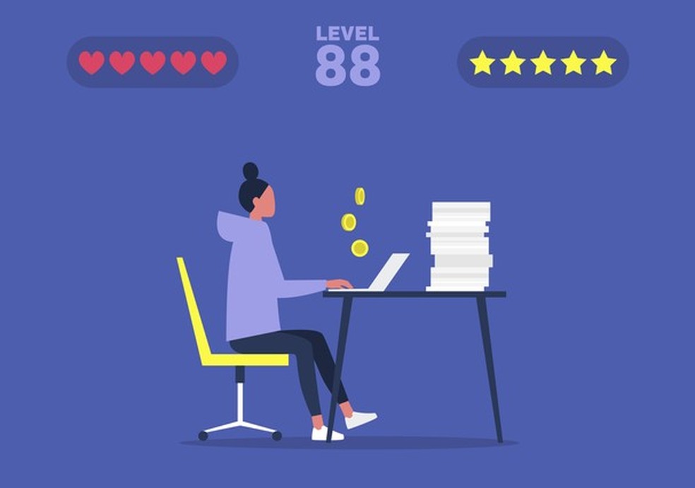 Office computer game, young female manager successfully passing the mission and earning coins, millennials at work (Foto: Getty Images/iStockphoto) — Foto: Glamour